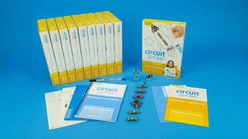 Circuit Scribe Kit shows the included modules, notebook, and conductive ink pen. Entry level electronics kit, eight pages of circuit drawing projects. Six modules are included.